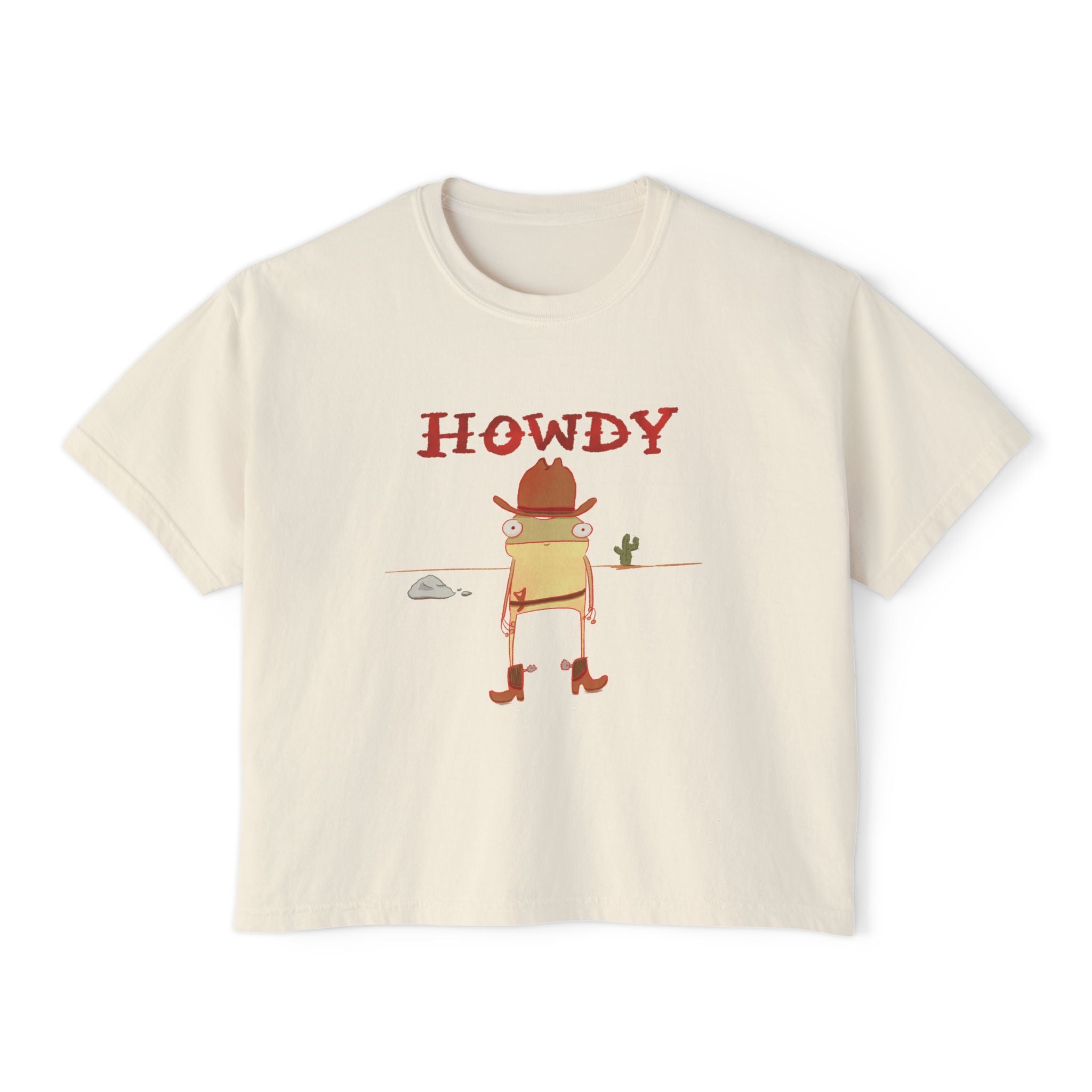 Beige t-shirt with 'HOWDY' and cowboy frog graphic on a white background