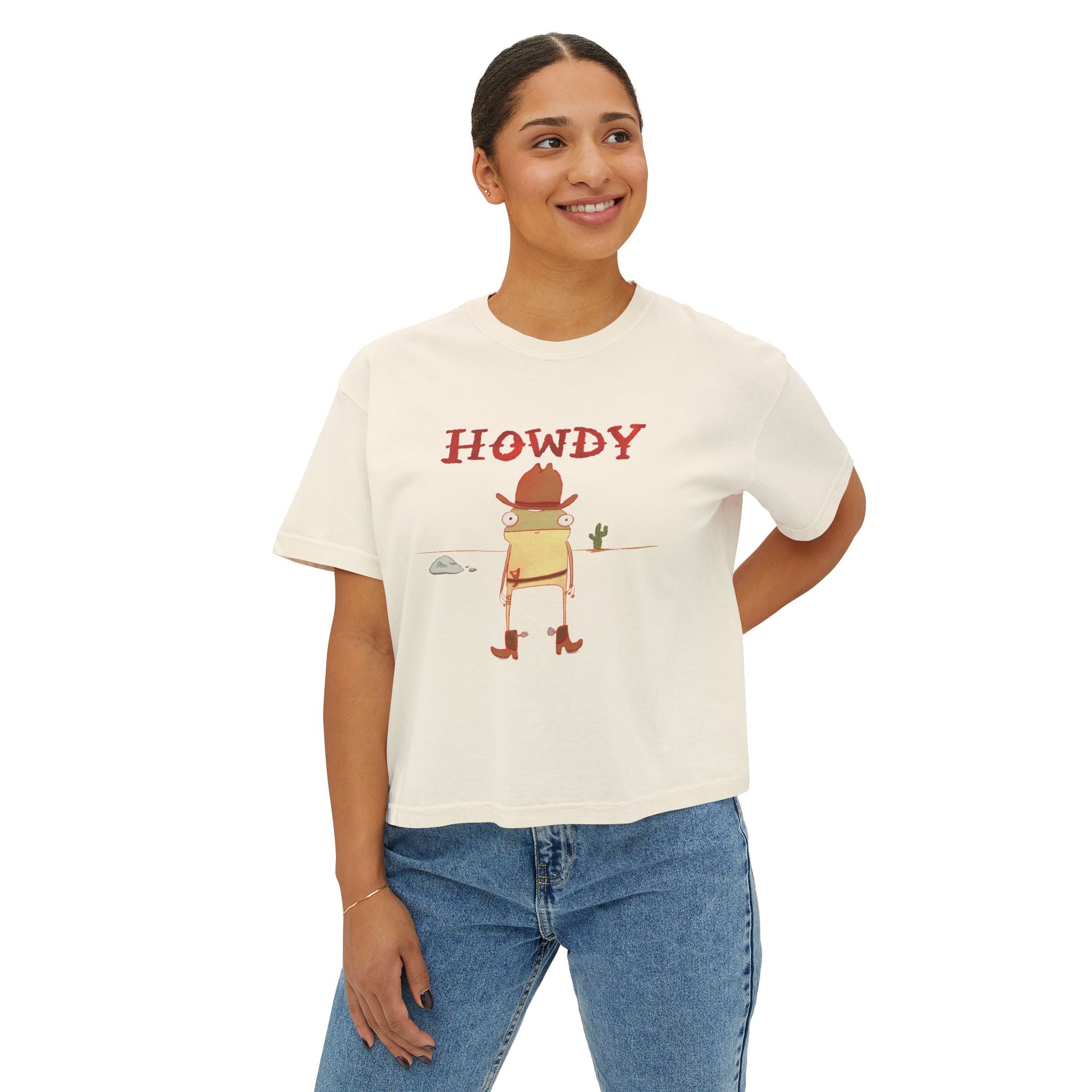Woman wearing a white t-shirt with 'HOWDY' and frog character on a white background