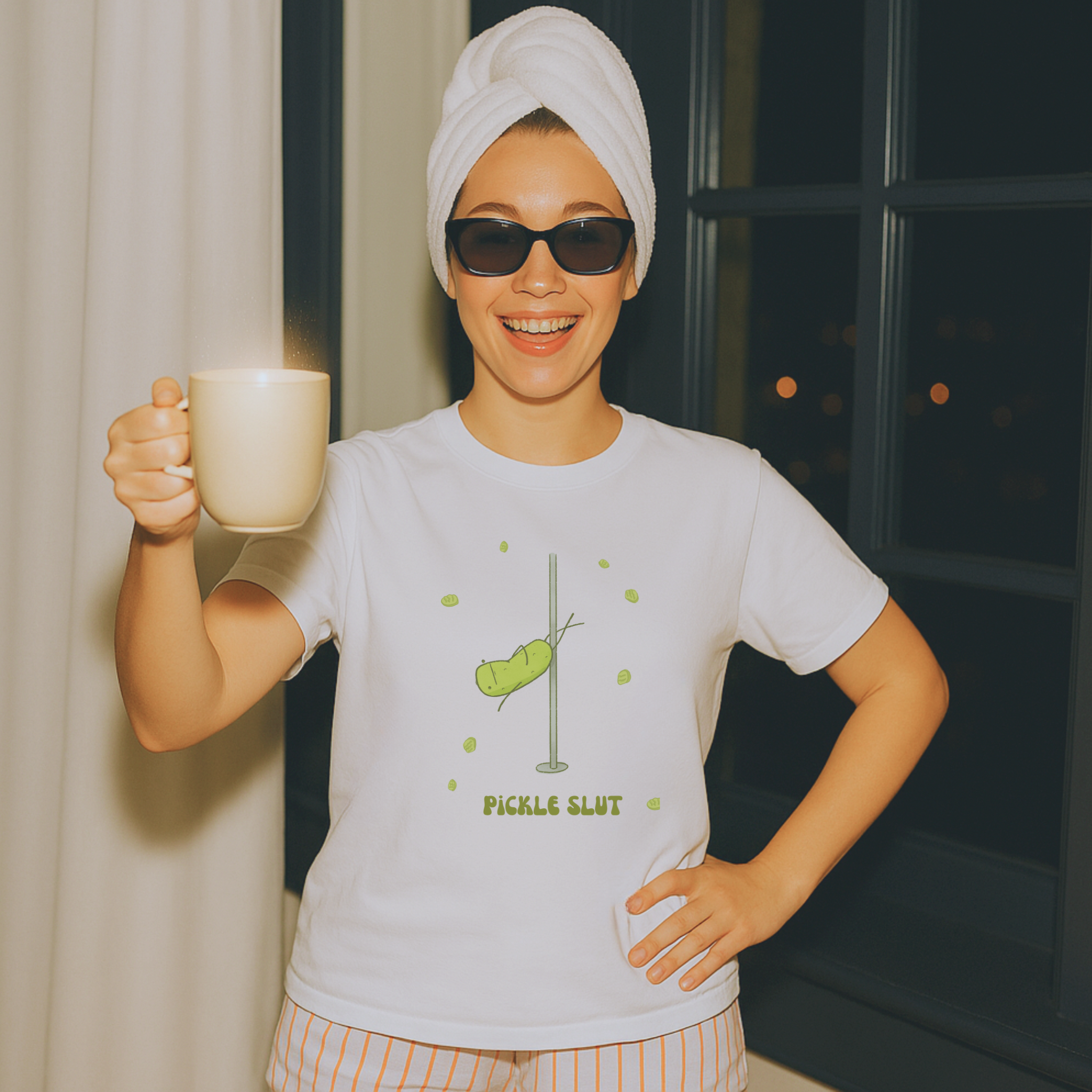 woman wearing a funny pickle t-shirt with pajama shorts holding a coffee mug