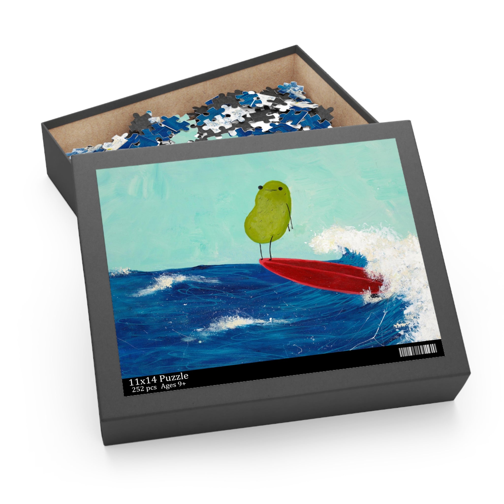 A pickle themed jigsaw puzzle is displayed in a partially opened puzzle box with the puzzle image on the top of the box