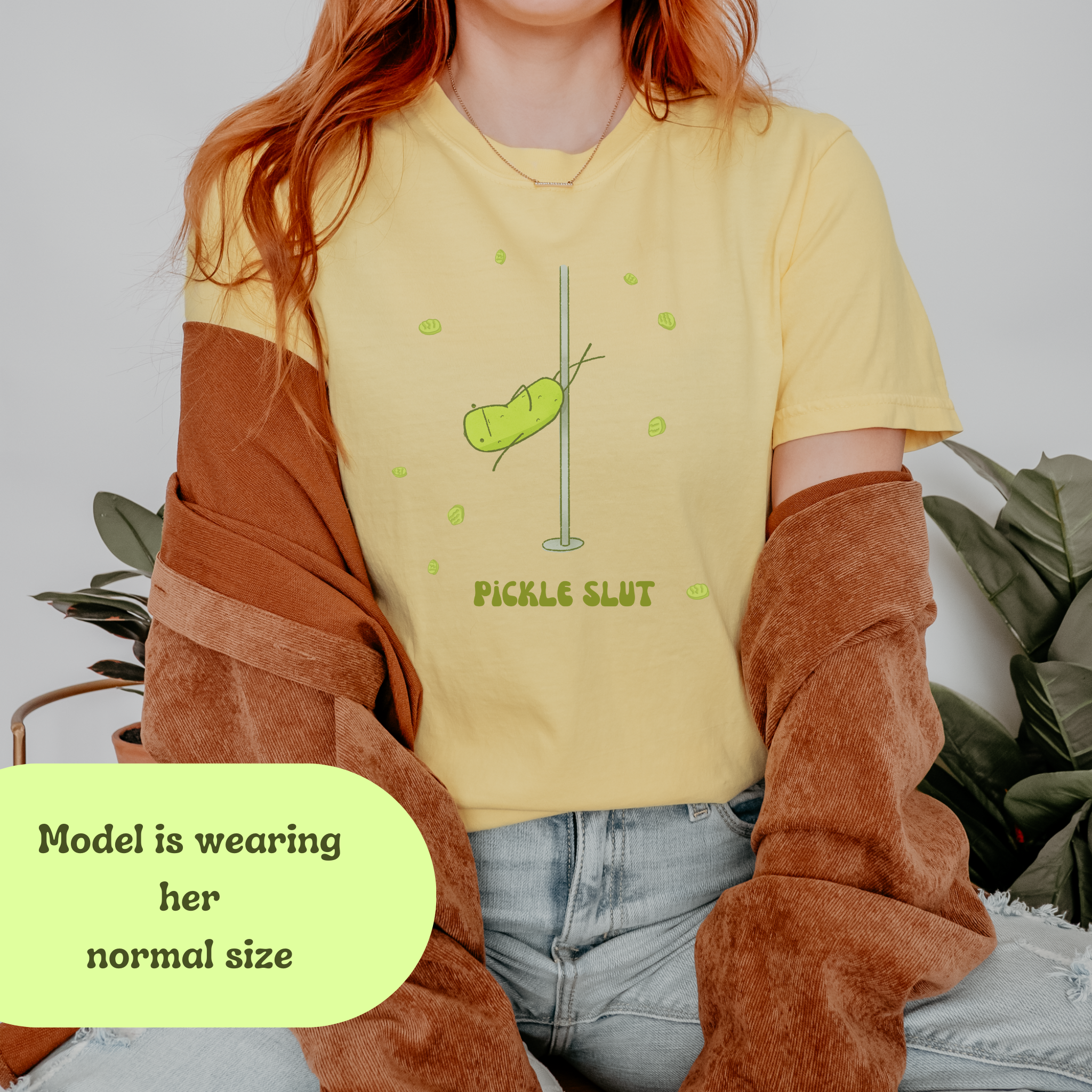 Person wearing a relaxed fit yellow 'Pickle Slut' t-shirt with pole dancing pickle graphic, styled for casual outfit